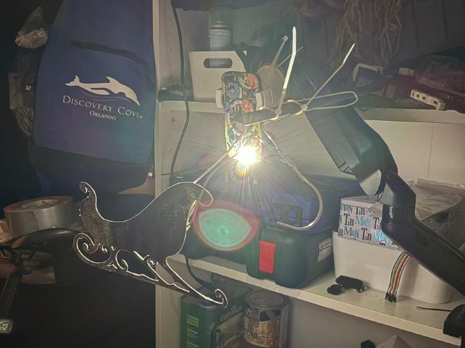 The convoluted setup to cast a shadow of the sleigh onto the plywood