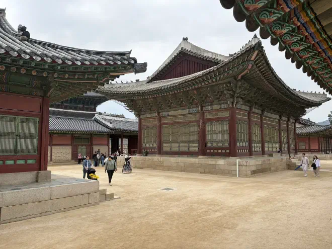 Wooden traditional Korean buildings with intricately painted eaves on stone platforms