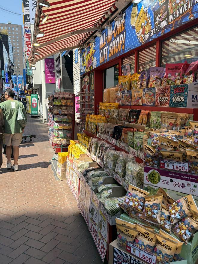 A stall outside a shop with various items for sale