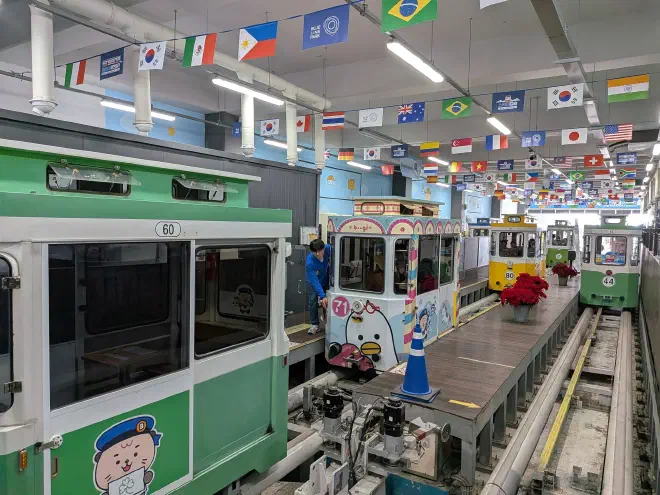 Small multi-coloured cabs arrive at a station