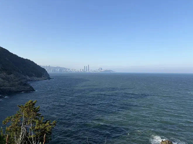 A calm ocean with a city in the distance