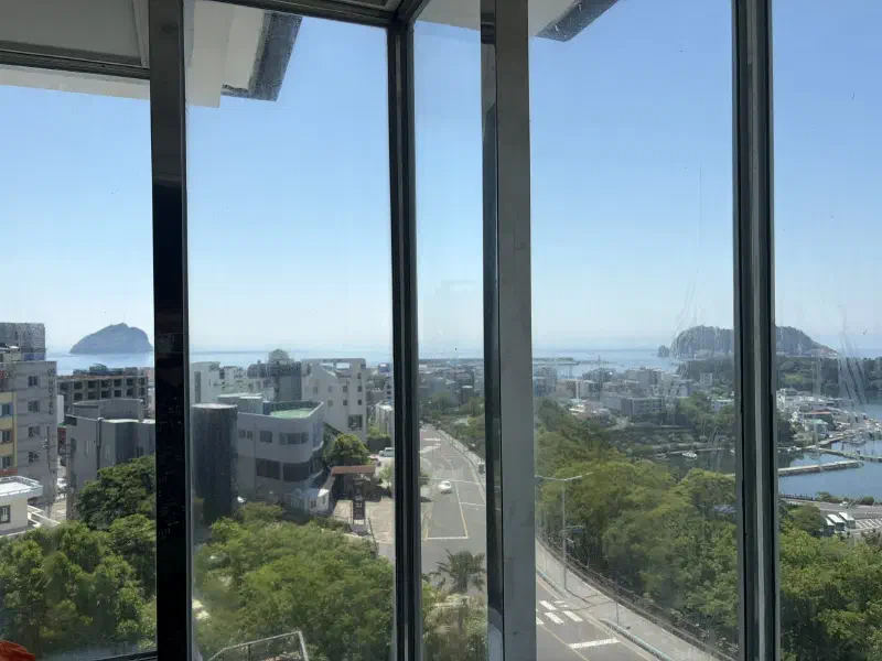 A window looking out to a city view of Seogwipo