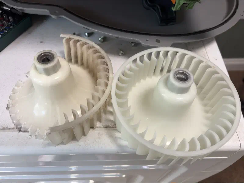 A faded broken impeller next to a new impeller