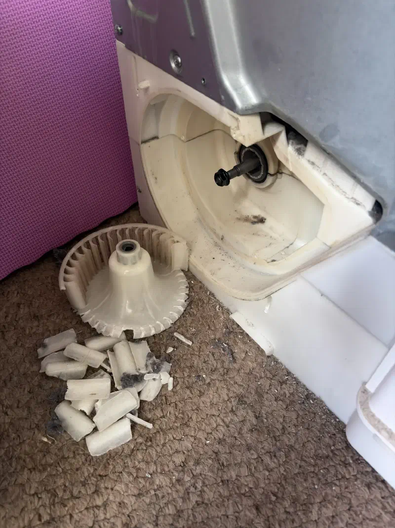 The back of a tumble dryer with a destroyed plastic impeller