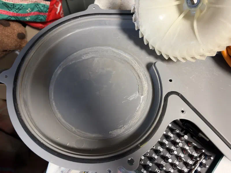 A grey plastic panel with circular friction mark on it